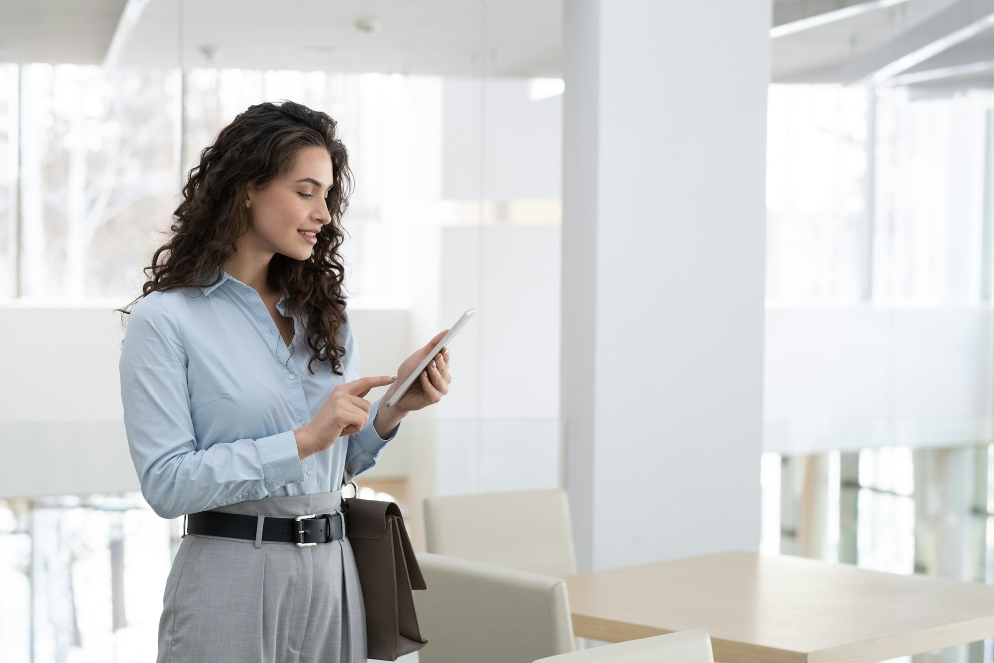 Young elegant female chief executive officer of modern high tech company